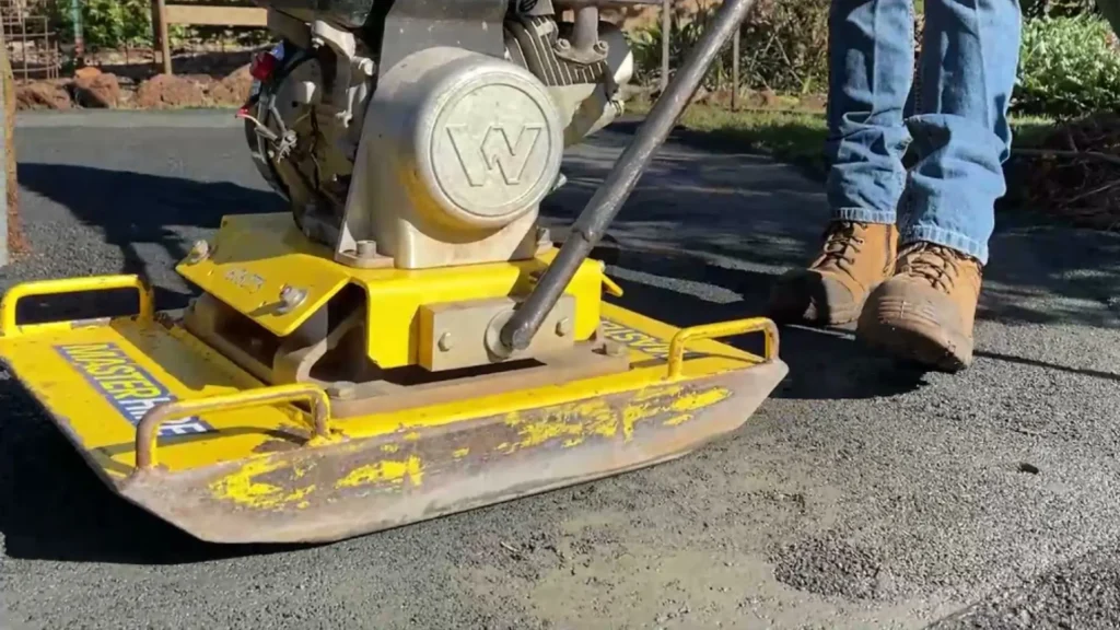 Using a plate compactor to create a level, solid base for a professional OneGrass synthetic turf installation