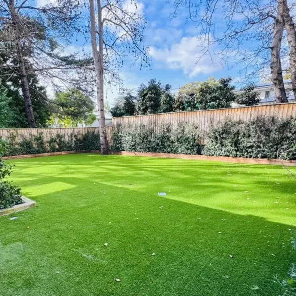 Vibrant OneGrass synthetic turf provides a lush, low-maintenance lawn for a residential backyard