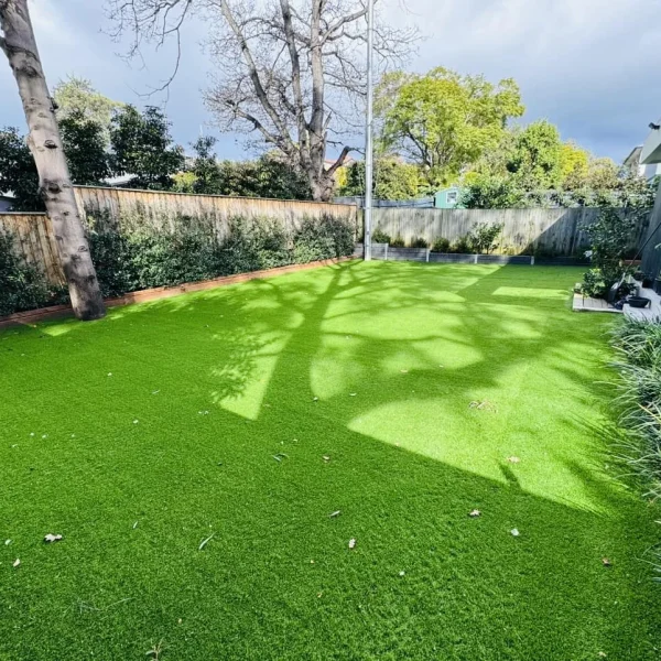 Lush OneGrass synthetic turf provides a clean, green play surface for a modern backyard