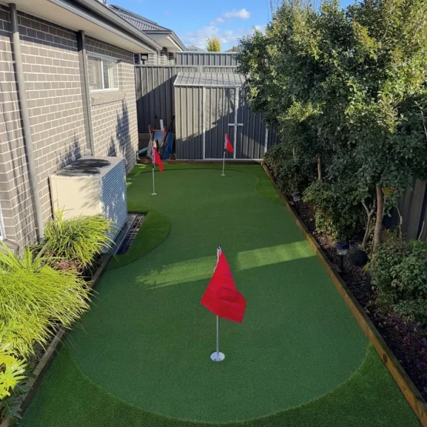 OneGrass synthetic turf with multiple golf holes and flags was professionally installed in a residential backyard