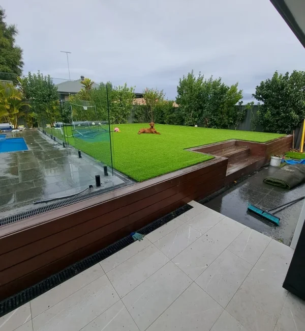 Lush OneGrass premium synthetic turf creates a vibrant, level backyard